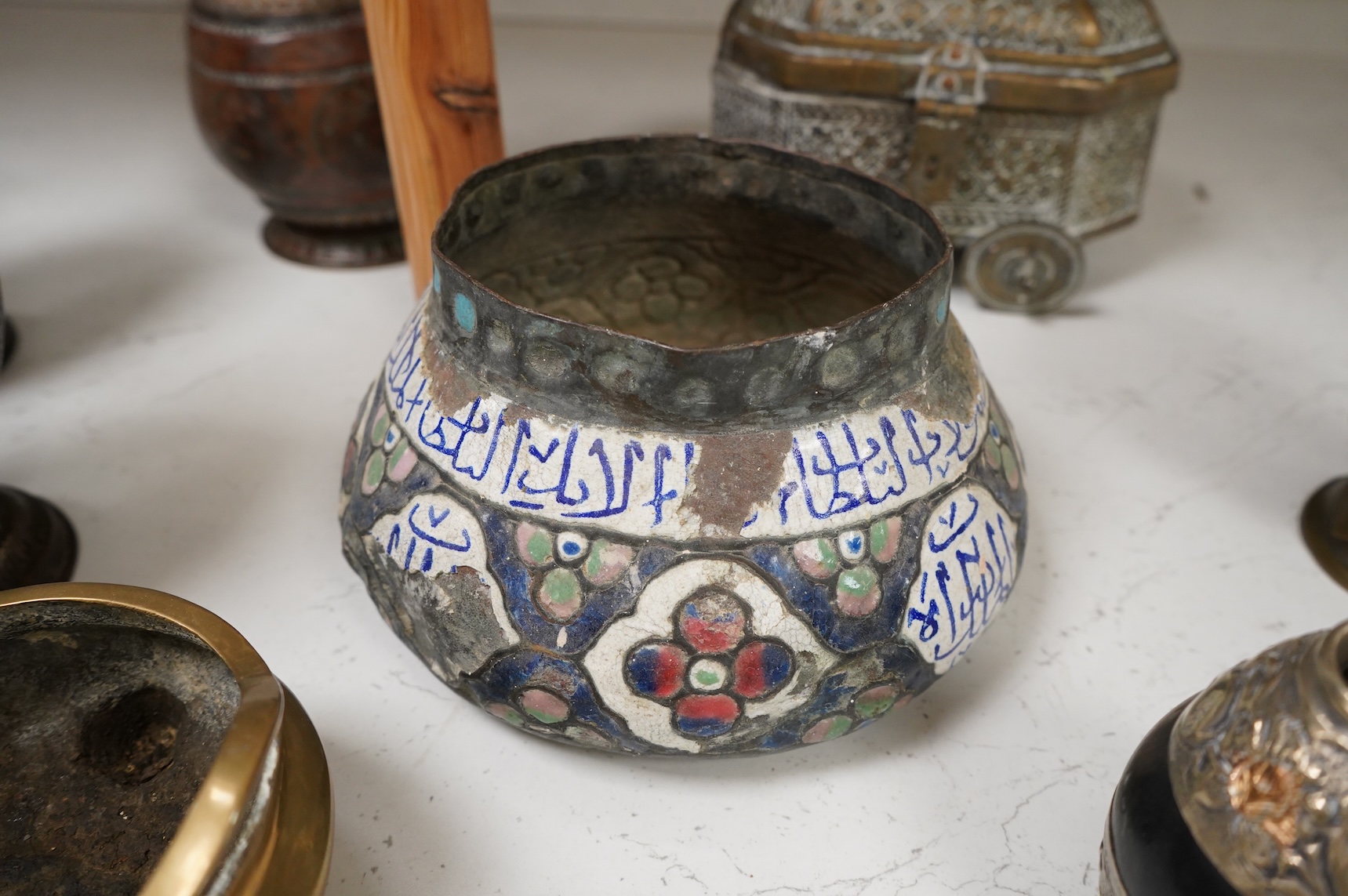 A collection of Persian, Eastern and Chinese metalware to include two brass tripod censers, pair of vases and an enamel bowl, largest 33cm high